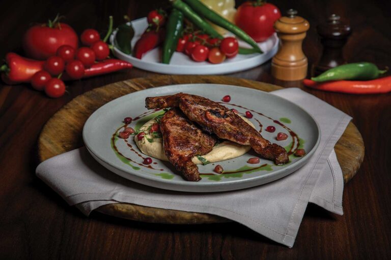 Lamb chops served with hummus and thabuleh salad / Cotlete de miel cu salată tabbouleh pe pat de humus